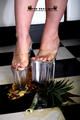 Heels crushing pineapple in the kitchen