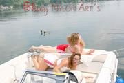 Stella and Leonie having a good time together on a boat sinbathing wearing sexy shiny nylon shorts and bikini-tops (Pics)