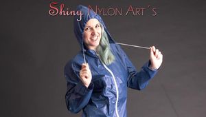 Mara posing in the studio wearing a blue rain skirt and a blue rain jacket as wellas red rubber boots (Pics)