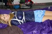Samantha tied and gagged wearing a beautiful lightblue nylon shorts and a darkblue rain jacket (Pics)