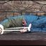 Jill tied and gagged in an old cellar wearing blue shiny nylon rainwear (Video)