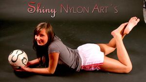 Alina wearing sexy white shiny nylon shorts and a grey top while posing with a soccer ball (Pics)