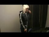 Blonde-haired archive girl going out wearing shiny nylon rainwear (Video)