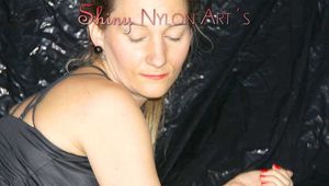 SEXY SANDRA wearing a black/red shiny nylon shorts and a black top during her workout with barbells (Pics)