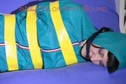 Mara tied and gagged with tape on a sofa wearing a supersexy shiny blue rain pants and a grren rain jacket (Pics) 
