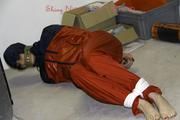 Shelly tied and gagged in shiny nylon rainwear
