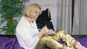Pia ties and gagges herself on a bed wearing a supersexy golden rainwear combination (Pics)