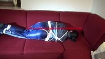 Lucy tied and gagged on a red sofa wearing a supersexy blue shiny nylon pants and a blue rain jacket (Video)