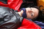 Simone tied and gagged in a big shiny nylon bag to lie in wearing a black shiny nylon shorts and a black shiny nylon rainjacket (Pics)