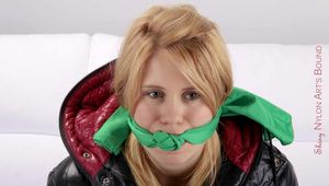 Samantha tied and gagged on a white sofa wearing a shiny red down pant and a black down jacket (Pics)