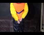 Sexy Mara trying on her new yellow down jacket and her lifevest in combination with a sexy shiny black rain pants and rubber boots (Video)