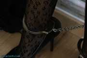 Leather lady cuffed to the heater