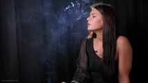 Asya is giving an interview while smoking two cigarettes