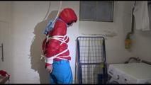 Mara tied, gagged and hooded in a laundry wearing a sexy blue down pants and a red down jacket (Video)