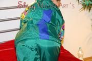Lucy putting on linen on bed wearing supersexy green shiny nylon rainwear (Pics)