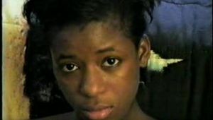 BLACK SHONDA IS RUBBER BAND BALL-GAGGED, MOUTH STUFFED, CLEAVE GAGGED & TIED BACKWARDS ON A CHAIR (D36-15)