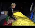 Sexy Sonja wearing a green shiny nylon shorts and a black rain jacket lolling in shiny nylon linen (Video)