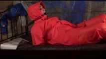 Jill tied, gagged and hooded on a princess bed wearing shiny orange rainwear (Video)