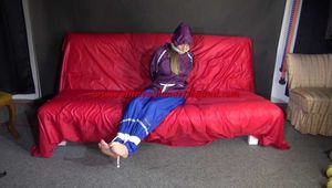 SANDRA being tied and gagged on a sofa with ropes and a clothgag wearing a sexy blue shiny nylon rain pants and a purple rain jacket  (Video)