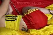 SEXY MARA ties and gagges herself with cuffs and a ball gag wearing a sexy red/yellow shiny nylon shorts and a sexy yellow top (Pics)