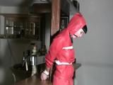 one of our archive girl tied and gagged in a shiny nylon rainsuit