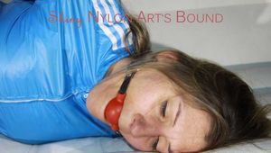 SEXY SANDRA being tied and gagged with ropes and a ballgag on a sofa wearing a SUPERSHINY NEW RED NYLON PANTS and a rain jacket (Pics)