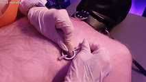 Mistress in apron needles nipples and sprays them on