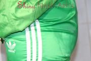 Sonja oiling and rinsing herself in the shower wearing a supersexy green shiny nylon shorts and rain jacket (Pics)