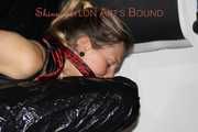 Sandra wearing a sexy black/red shiny nylon shorts and a black top being tied and gagged with ropes on a sofa (Pics)
