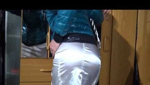 SONJA in high heels wearing a sexy white shiny nylon skirt and a green down jacket posing infront of the mirror (Video)