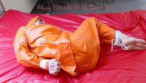 Pia tied and gagged in bed in a orange rainsuit and a red gag (Pics)