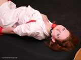 Barefoot nurse Gatitta tied up with a red rope