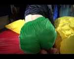 Sexy Sonja wearing a green shiny nylon shorts and a black rain jacket lolling in shiny nylon linen (Video)