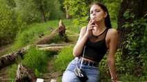 18 years old Tanya is smoking 120mm cork cigarette outdoors