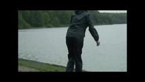 Sexy archive girl wearing shiny nylon shorts and puts on a rain pants and jacket (Video)