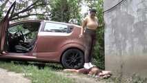 Mistress Jenna stands on the slave with a car while smoking in the slave's mouth A