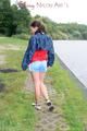 Sexy archive girl walking on a lake wearing a sexy shiny nylon shorts and an oldschool rain jacket (Pics)
