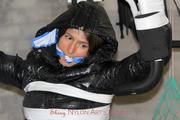 Katharina tied and gagged in a shiny nylon downcoat and shiny nylon pants