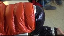 Mara tied and gagged on a table wearing a sexy black down pants and an orange down jacket (Video)