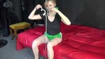*** Sexy MIA wearing a green shiny nylon shorts and a black top ties and gagges herself with cuffs and a clothgag on a bed (Video)***