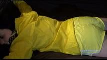 Lucy tied and gagged on a bed wearing a supersexy rarely yellow shiny nylon shorts and a yellow rain jacket (Video)