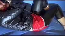 Mara ties and gagges herself with handcuffs wearing shiny nylon shorts over an leggins and a rain jacket (Video)