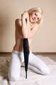 Topless barefoot Hannah, bound with her hands tied up in front of her, poses with umbrella