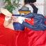 Sonja tied and gagged with ropes and cloth gag on a bed wearing a sexy oldschool darkblue shiny nylon shorts and red/blue rain jacket (Pics)