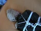 a video with one of our archive girls bound and gagged in a shiny black PVC sauna suit