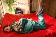 Lucy tied and gagged on bed wearing a sexy green rainwear combination (Pics)