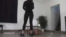 Mistress Cleo squirts cologne into the mouth of the slave lying in the toilet.