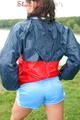 Sexy archive girl walking on a lake wearing a sexy shiny nylon shorts and an oldschool rain jacket (Pics)