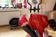 Mara wearing a red shiny nylon shorts, a black shiny leggins and a red rain jacket doing her workout (Pics)