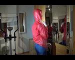 Watch Sonja to dress herself with rainwear and begin her workout on the home trainer (Video)